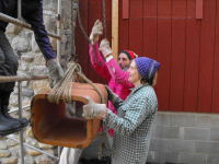 Steve and Marilyn raise another flue section.